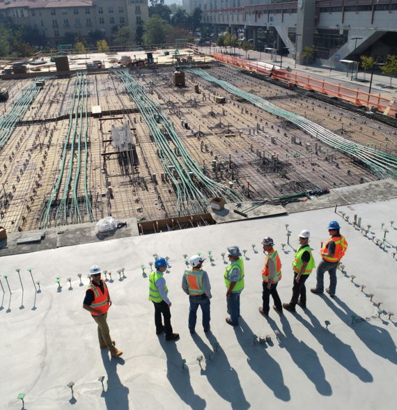 seven construction workers standing on white field